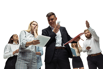 Image showing Nervous tensioned investors analyzing crisis stock market with charts on screen of their gadgets