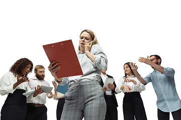 Image showing Nervous tensioned investors analyzing crisis stock market with charts on screen of their gadgets