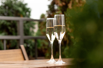 Image showing Glasses of sparkling champagne, close up. Warm colored. Celebration event, holidays, drinks concept