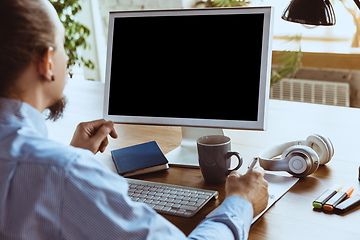 Image showing Man working from home during coronavirus or COVID-19 quarantine, remote office concept.