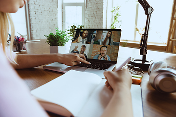 Image showing Remote meeting. Woman working from home during coronavirus or COVID-19 quarantine, remote office concept.