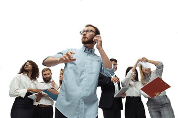 Image showing Nervous tensioned investors analyzing crisis stock market with charts on screen of their gadgets