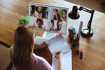 Image showing Remote meeting. Woman working from home during coronavirus or COVID-19 quarantine, remote office concept.