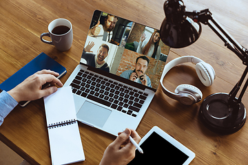 Image showing Remote meeting. Man working from home during coronavirus or COVID-19 quarantine, remote office concept.