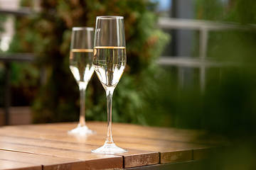 Image showing Glasses of sparkling champagne, close up. Warm colored. Celebration event, holidays, drinks concept