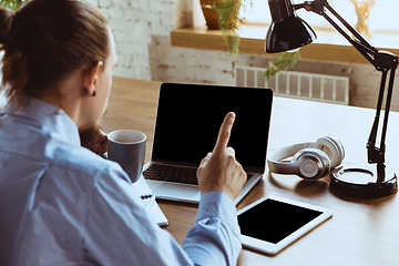 Image showing Man working from home during coronavirus or COVID-19 quarantine, remote office concept.