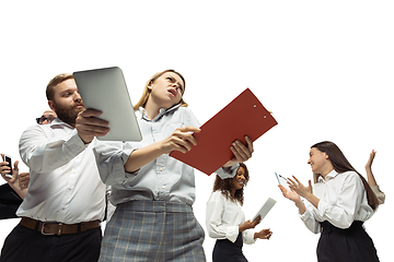 Image showing Nervous tensioned investors analyzing crisis stock market with charts on screen of their gadgets