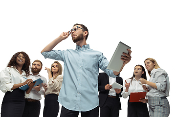 Image showing Nervous tensioned investors analyzing crisis stock market with charts on screen of their gadgets