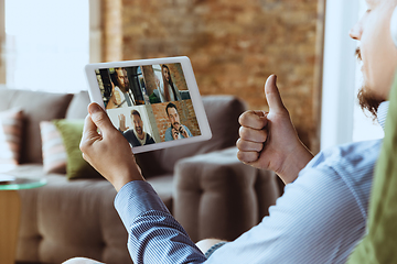 Image showing Remote meeting. Man working from home during coronavirus or COVID-19 quarantine, remote office concept.