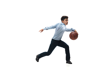 Image showing Man in office clothes playing basketball on white background. Unusual look for businessman in motion, action. Sport, healthy lifestyle.