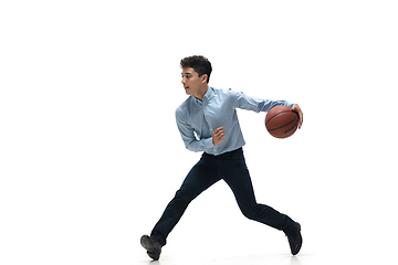 Image showing Man in office clothes playing basketball on white background. Unusual look for businessman in motion, action. Sport, healthy lifestyle.