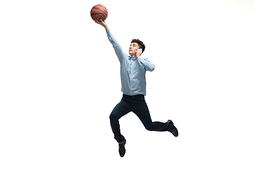 Image showing Man in office clothes playing basketball on white background. Unusual look for businessman in motion, action. Sport, healthy lifestyle.