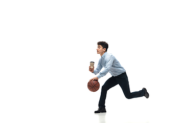 Image showing Man in office clothes playing basketball on white background. Unusual look for businessman in motion, action. Sport, healthy lifestyle.