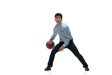 Image showing Man in office clothes playing basketball on white background. Unusual look for businessman in motion, action. Sport, healthy lifestyle.