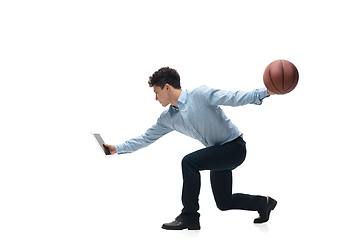 Image showing Man in office clothes playing basketball on white background. Unusual look for businessman in motion, action. Sport, healthy lifestyle.