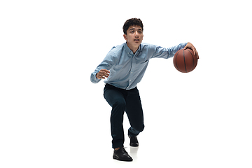 Image showing Man in office clothes playing basketball on white background. Unusual look for businessman in motion, action. Sport, healthy lifestyle.