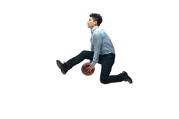 Image showing Man in office clothes playing basketball on white background. Unusual look for businessman in motion, action. Sport, healthy lifestyle.