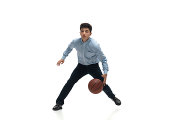 Image showing Man in office clothes playing basketball on white background. Unusual look for businessman in motion, action. Sport, healthy lifestyle.