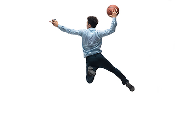 Image showing Man in office clothes playing basketball on white background. Unusual look for businessman in motion, action. Sport, healthy lifestyle.