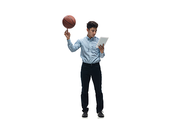 Image showing Man in office clothes playing basketball on white background. Unusual look for businessman in motion, action. Sport, healthy lifestyle.