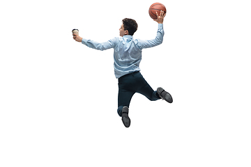 Image showing Man in office clothes playing basketball on white background. Unusual look for businessman in motion, action. Sport, healthy lifestyle.