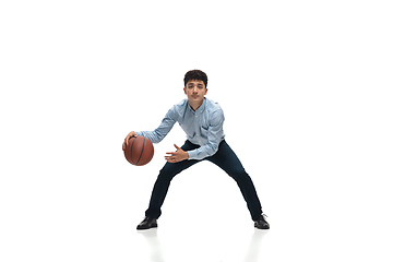 Image showing Man in office clothes playing basketball on white background. Unusual look for businessman in motion, action. Sport, healthy lifestyle.