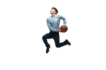 Image showing Man in office clothes playing basketball on white background. Unusual look for businessman in motion, action. Sport, healthy lifestyle.