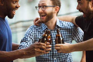 Image showing Group of happy friends having beer party in summer day. Resting together outdoor, celebrating and relaxing, laughting. Summer lifestyle, friendship concept.