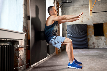 Image showing young man exercising with medicine ball in gym