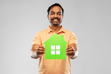 Image showing smiling indian man holding green house icon