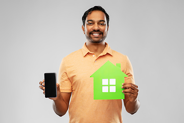 Image showing happy indian man with green house and smartphone