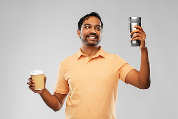 Image showing man comparing thermo cup or tumbler and coffee cup