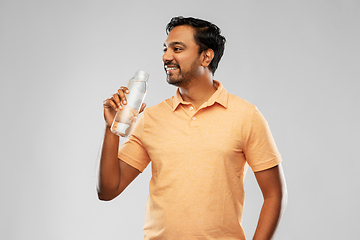 Image showing happy indian man drinking water from glass bottle