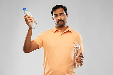 Image showing indian man comparing water in different bottles