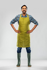 Image showing happy indian male gardener or farmer in apron