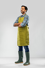 Image showing happy indian male gardener or farmer in apron