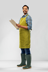 Image showing happy indian gardener or farmer with clipboard