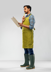 Image showing indian gardener or farmer with clipboard thinking