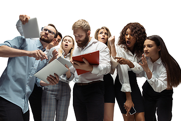 Image showing Nervous tensioned investors analyzing crisis stock market with charts on screen of their gadgets