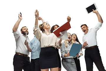 Image showing Hopeful and happy investors analyzing crisis stock market with charts on screen of their gadgets