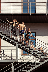 Image showing The group of modern ballet dancers performing on the stairs at the city