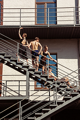 Image showing The group of modern ballet dancers performing on the stairs at the city