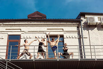 Image showing The group of modern ballet dancers performing on the stairs at the city