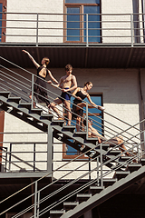 Image showing The group of modern ballet dancers performing on the stairs at the city