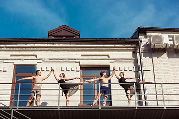 Image showing The group of modern ballet dancers performing on the stairs at the city