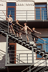 Image showing The group of modern ballet dancers performing on the stairs at the city