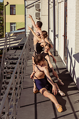 Image showing The group of modern ballet dancers performing on the stairs at the city