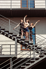 Image showing The group of modern ballet dancers performing on the stairs at the city