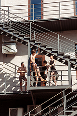 Image showing The group of modern ballet dancers performing on the stairs at the city