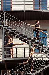 Image showing The group of modern ballet dancers performing on the stairs at the city